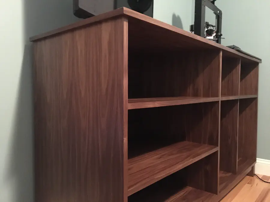 Cabinet is placed in the corner of the office with nothing inside yet. There is a 3D printer and television on top