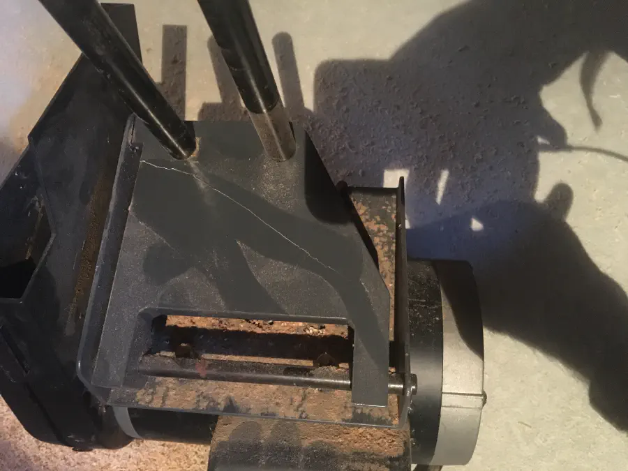 A bracket for holding the table saw motor, snapped in half