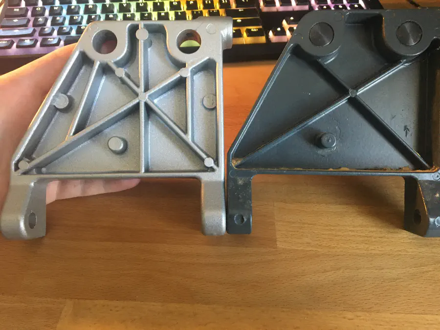 A cracked motor mount bracket and a new re-inforced one from SawStop