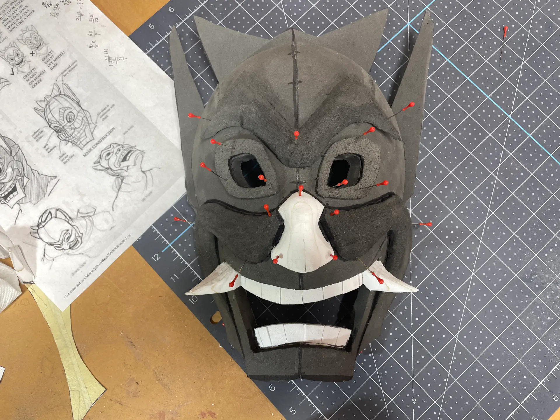Overtop the teeth are two fang-like teeth, also white EVA foam.