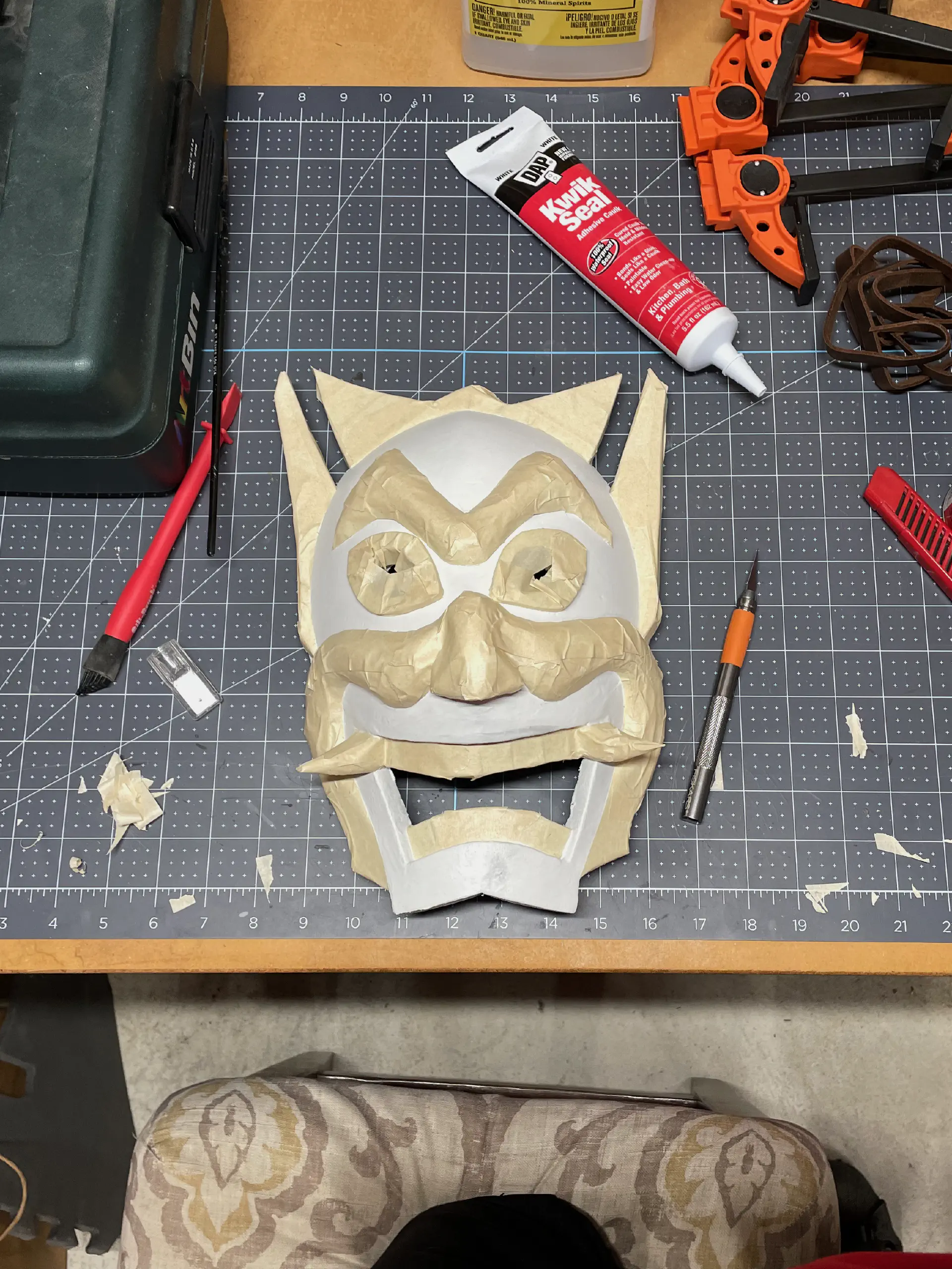 Using masking tape, the white details are covered to paint the rest blue.
