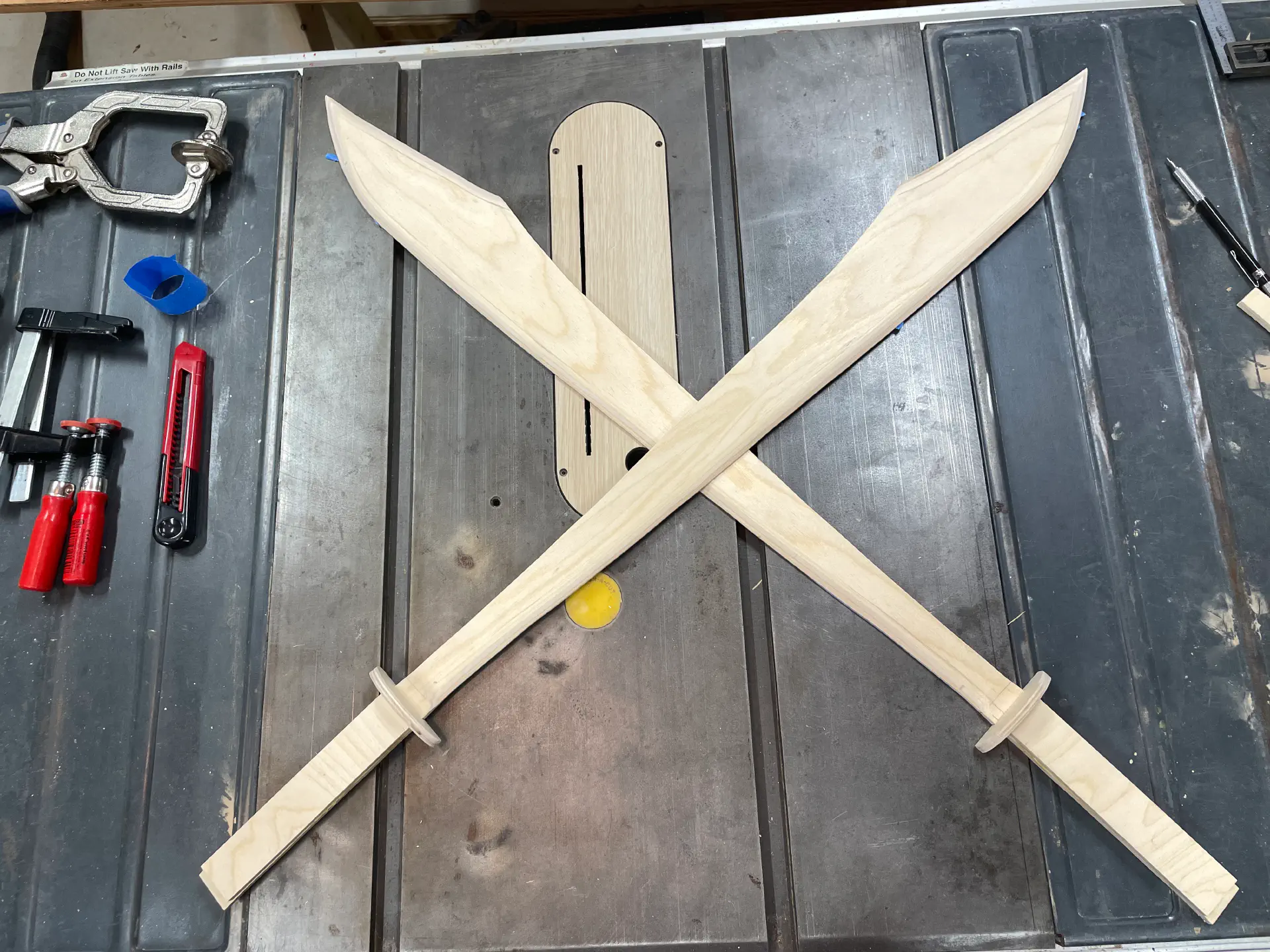 Crossed swords again, but with a plywood guard.