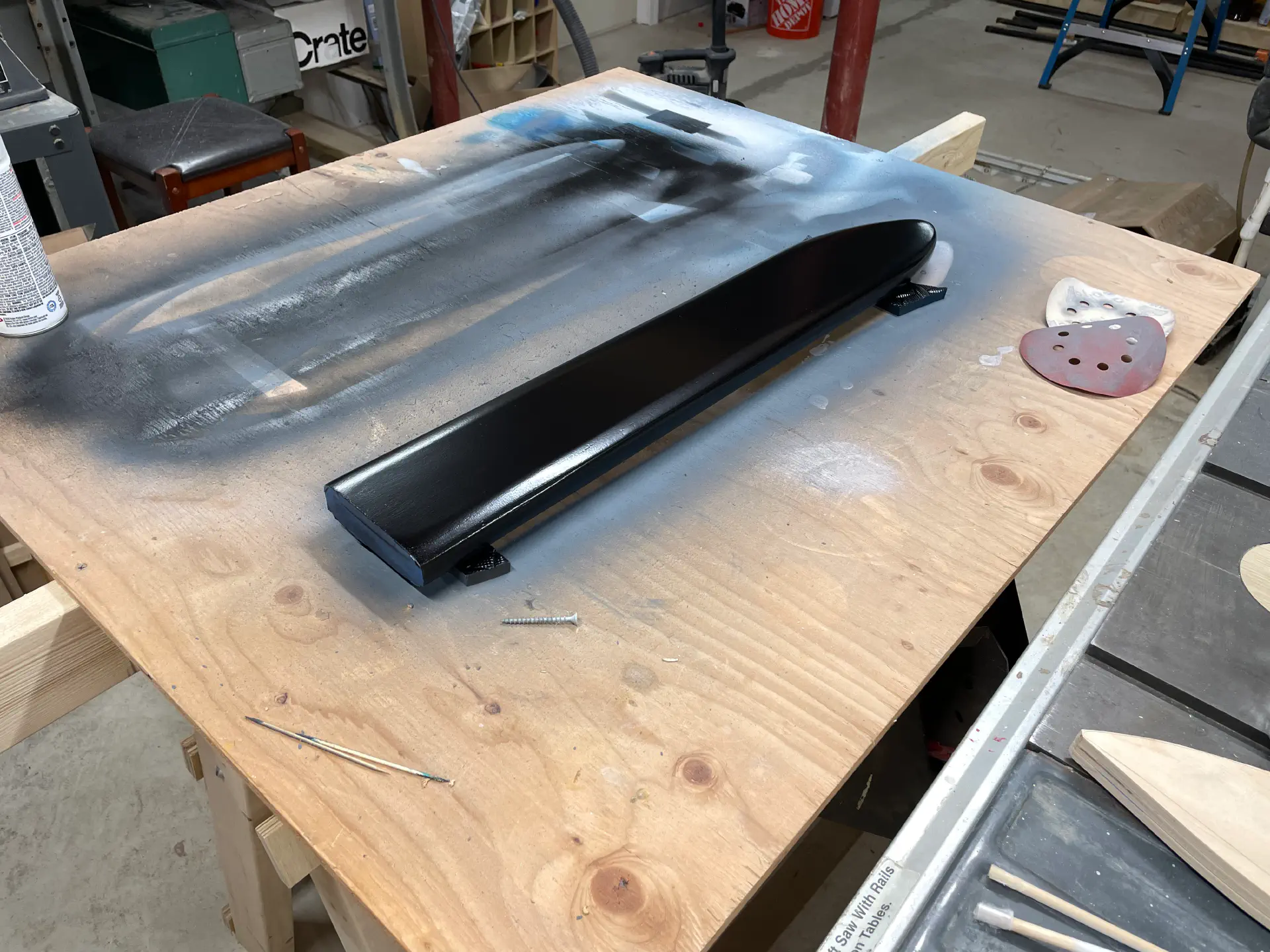 A fairly chunky sword sheath, also made from plywood, painted black.