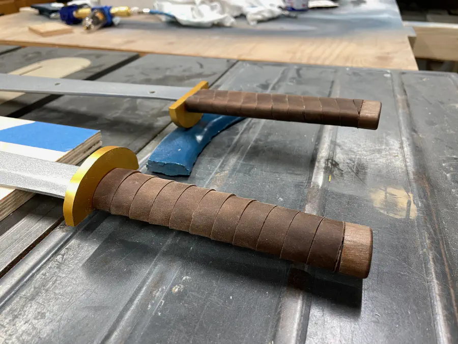 A close up of the leather wrapped hilt and wooden pommel.