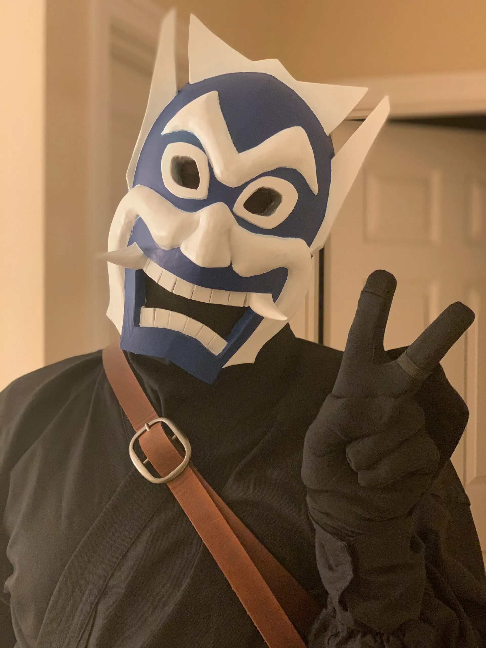 An indoor shot wearing the mask, sheath and 'ninja' uniform. I am holding up a 'peace' sign.